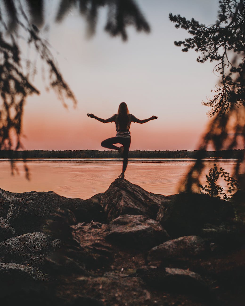 a person standing on the rock doing yoga