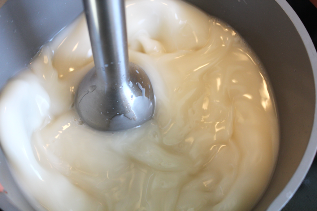 Immersion blender bringing lye and oil mixture to trace for soap making