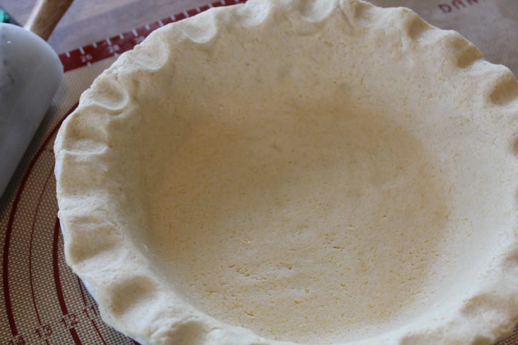 Close up of gluten-free pie crust in a pie tin