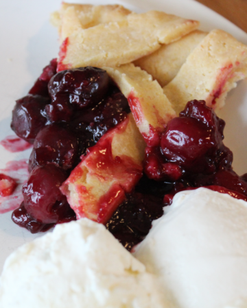 slice of cherry pie with two scoops of ice cream